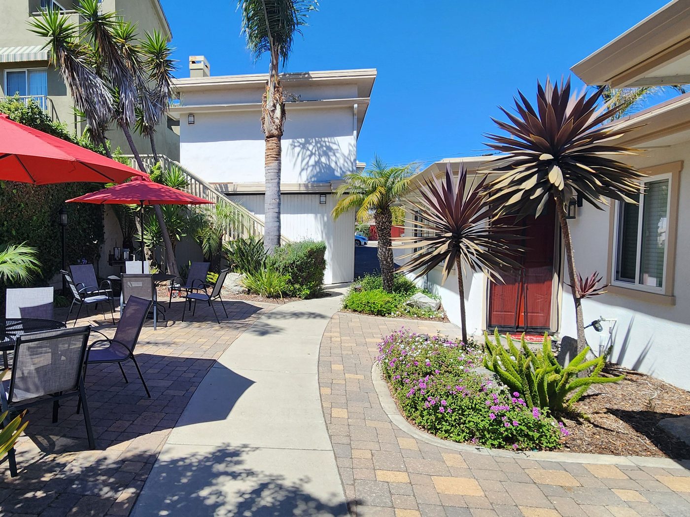 The paver walkway running through the courtyard toward the cottages