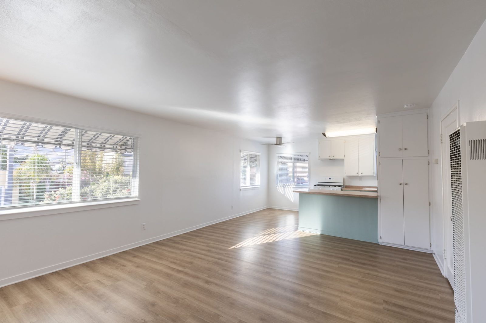 The open living room in Apartment 1, looking toward the kitchen and dining area