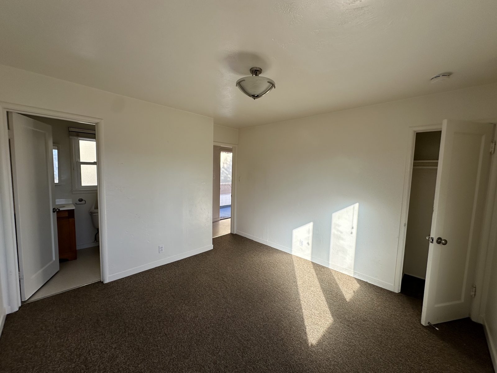 A bedroom in Apartment 2 with its own bathroom and a closet