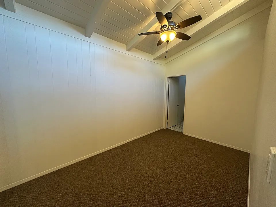 The bedroom in Apartment 5 with a ceiling fan